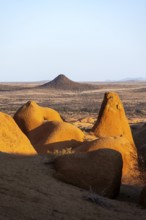 Red rocks rise above the vast dry plain of the Spitzkoppe Desert, Spitzkoppe, Namibia