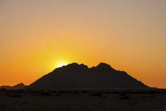 Sunset behind a distinctive mountain silhouette in the wilderness of Spitzkoppe, Spitzkoppe,