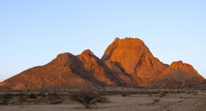 Spitzkoppe rocks at dusk with sparse vegetation in the foreground, Spitzkoppe, Namibia