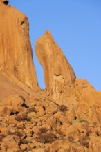 Distinctive rock formations rise into the clear blue sky in the desert landscape of Spitzkoppe,