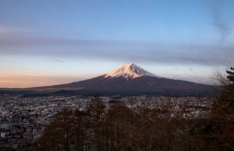 View of Mount Fuji volcano over Fujiyoshida City, at sunrise, Arakurayama Sengen Park, Yamanashi