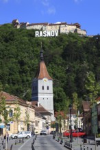 Town of Rasnov, German Rosenau. In the foreground is the distinctive clock tower of the Protestant