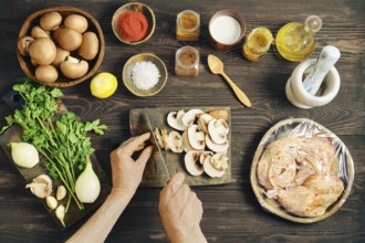 High angle view of person cutting mushroom for a meal. Lifestyle food preparation with wrapped