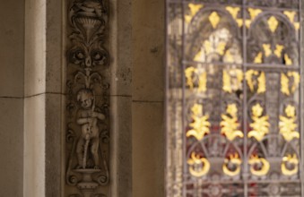 Decorative bas-relief with floral motifs, arabesques and car, gilded entrance gate in the