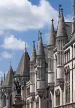 Royal Courts of Justice, neo-gothic architecture with towers under blue sky, London, England, Great