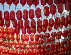 Red Chinese lanterns hang close together under the open sky, London, England, Great Britain