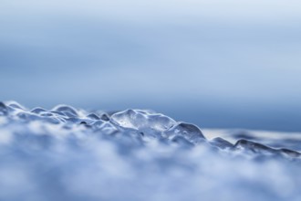 Close-up of ice-covered water in various shades of blue with a mystical aura, Korpoström, Korpo or