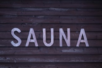 Rustic wooden wall sign with the inscription 'Sauna', Korpoström, Korpo or Korppo, Southwestern