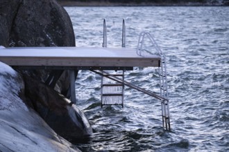 Jetty on a wintry coast with waves and icicles on a staircase, Korpoström, Korpo or Korppo,