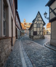 Narrow alley with half-timbered houses and cobblestones at Finkenherd in the historic old town, in