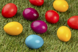 Colourful Easter eggs spread on green grass