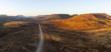 Aerial view, road leading through dry desert landscape, hills in Damaraland, Namibia