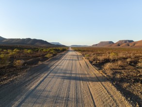 Beautiful dirt road through dry desert landscape, hills in Damaraland, Namibia