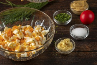 Ingredients arranged in trays for egg cream on a wooden table