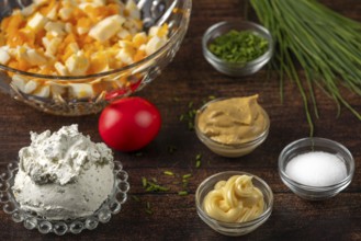Eggs, cream cheese and spices for a spread in bowls