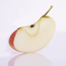 Apple cleft (Malus domestica) in front of a white background, studio shot