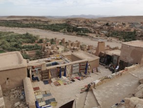Carpet market on a hill overlooking an oasis and surrounding buildings, Morocco
