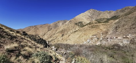 Panorama of a rural settlement in a barren mountain landscape, Atlas Mountains, Morocco