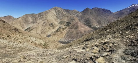 Panorama of a dry, rocky mountain landscape under clear sky, Atlas Mountains, Morocco