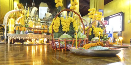 Sacrifices with candles, in front of numerous Buddhas and the City Pillar, which is considered the