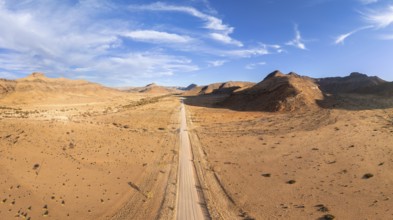 Aerial view, Eternally long straight road, road C14 through the Naukluft Mountains, desert and dry
