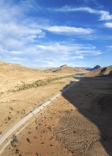 Aerial view, Eternally long straight road, road C14 through the Naukluft Mountains, desert and dry