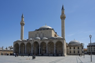 A historic mosque with two minarets and multiple domes under a clear blue sky, mosque, Konya Sultan
