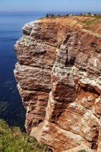 Red cliffs under a clear sky with the blue sea, the high-seas island of Heligoland in the North Sea