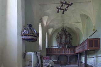 Interior with baroque organ of the abandoned 16th century Protestant fortified church, Tobsdorf,