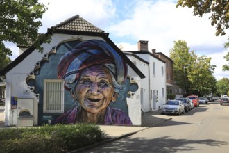 Graffiti portrait of an elderly woman from Bali. The work of art is part of the Kultur aus Tausch