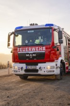 A MAN fire engine with the inscription 'FIRE DEPARTMENT' is parked on the side of the road when the