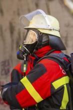 Firefighter wearing a respirator and protective clothing in a tunnel during an operation, fire