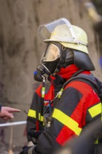 Firefighter with respirator and helmet, focused and ready for rescue measures, fire brigade