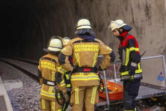 Fire team wearing protective clothing during a rescue operation in a railway tunnel, fire brigade