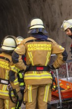 Firefighters in protective clothing prepare for a mission in a tunnel, fire brigade exercise at the