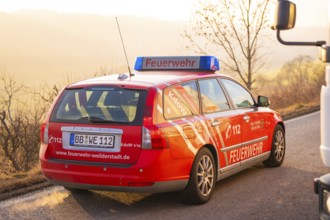 A red fire department car outside, rear view with sunset, fire brigade exercise on the Hermann
