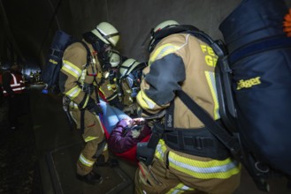 Firefighters rescue an injured person in a tunnel with a stretcher, fire brigade exercise on the
