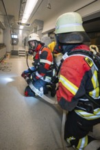 Firefighters are getting ready for a mission inside a train, fire brigade exercise on the Hermann
