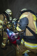 Firefighters free a person in a tunnel with a stretcher, fire brigade exercise on the Hermann Hesse