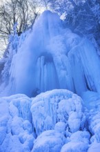 Urach waterfall full of bizarre ice formations frozen at winter temperatures, Bad Urach, Swabian