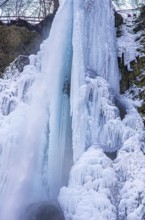 Urach waterfall full of bizarre ice formations frozen at winter temperatures, Bad Urach, Swabian