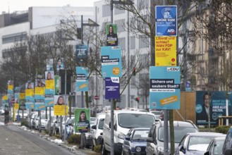 Numerous election posters for the 2026 local elections are hanging one behind the other on several