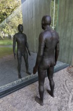 Male figure looking at her real reflection, Reflections II sculpture by sculptor Antony Gormley,