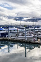 Boats in harbor, cloudy mountain peaks behind, with reflection, Seward, Kenai Peninsula, Alaska,