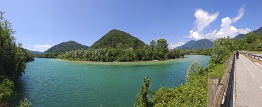 Panoramic view of lake with surrounding mountains and road on the edge, Slovenia
