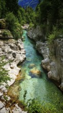 Crystal-clear river flows through a narrow, rock-lined gorge, Soca Valley, Slovenia