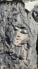 Natural formation of a face in a rock wall, Slovenia