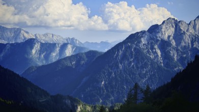 Mountain range in deep blue shadows under glowing sky, Slovenia