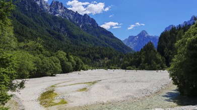Wide valley with mountains and riverbed in the foreground, Slovenia