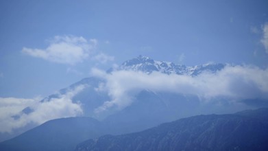 Snowy mountain peaks of Tahtali Dagi jut out of surrounding clouds, Lycia, Turkey